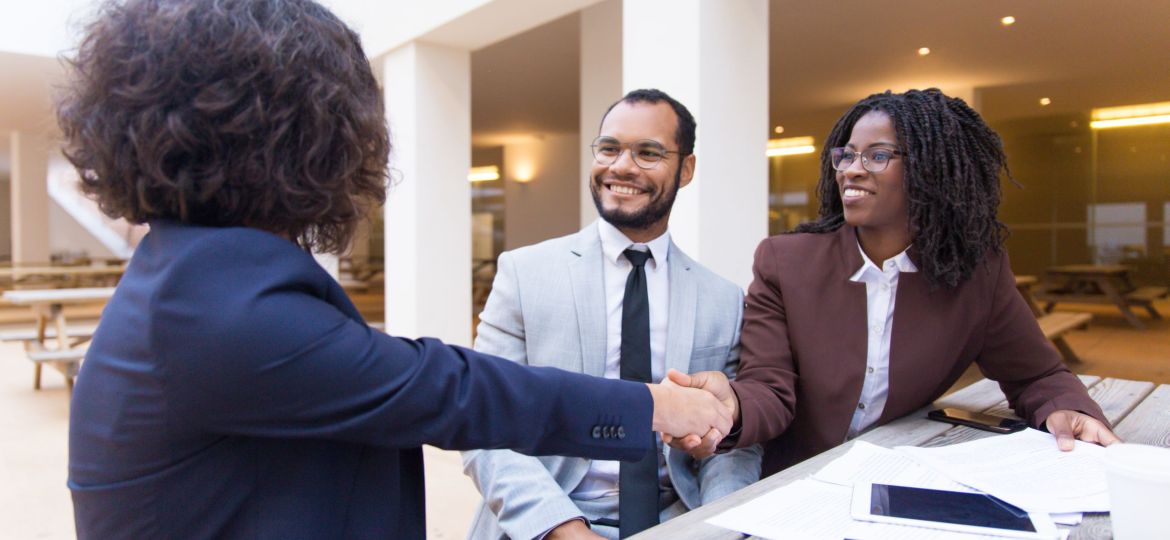 Satisfied customers thanking professional for help